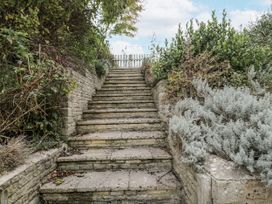 A pathway leading up stone stairs with greenery at The Old Hall in Tetbury