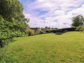 A garden with grass and trees at The Old Hall Westonbit Nr Tetbury