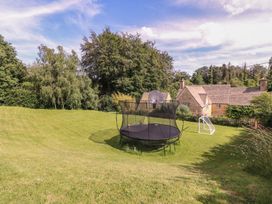 An outdoor area with a trampoline and soccer goal at The Old Hall Westonbit Nr Tetbury