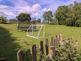 A garden with a goal post and trampoline at The Old Hall Westonbit Nr Tetbury