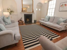 A living room with sofas and a fireplace at Scillonia in Penzance