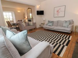 A living room with sofas and a dining area at Scillonia in Penzance