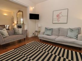 A living room with a sofa and armchair at Scillonia in Penzance