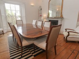 A dining room with a table and chairs at Scillonia in Penzance