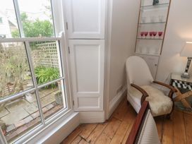 A sitting room with a window and chair at Scillonia in Penzance