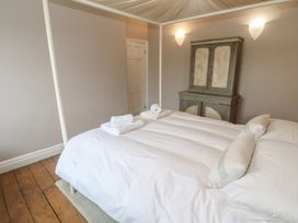 A bedroom with a bed and wardrobe at Scillonia in Penzance