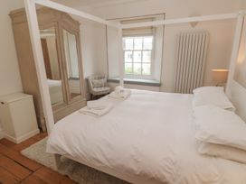 A bedroom with a bed and wardrobe at Scillonia in Penzance
