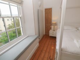 A bedroom with a bed and bedside table at Scillonia in Penzance
