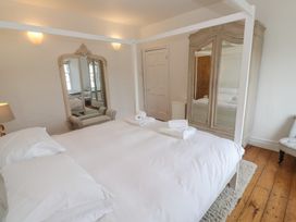 A bedroom with a bed and a wardrobe at Scillonia in Penzance