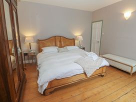 A bedroom with a bed and wardrobe at Scillonia in Penzance