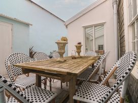 A dining area with a table and chairs at Scillonia in Penzance