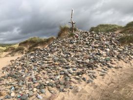 A pile of stones with driftwood at Tower Cottage Near Pembroke