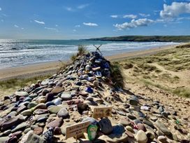 A pile of decorated stones at a beach near the ocean at Tower Cottage near Pembroke