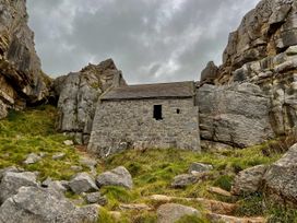 A stone building surrounded by rocks at Tower Cottage Near Pembroke