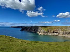 A coastline with cliffs and water at Tower Cottage Near Pembroke