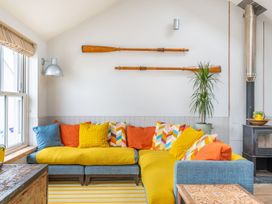 A living room with a sofa and cushions at 14 Marine Parade Lyme Regis
