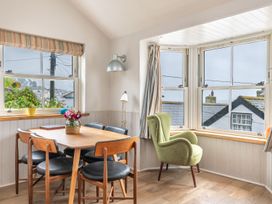 A dining room with a table and chairs at 14 Marine Parade Lyme Regis