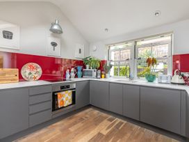 A kitchen with appliances and a window at 14 Marine Parade in Lyme Regis