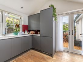 A kitchen with cabinets and a window at 14 Marine Parade in Lyme Regis