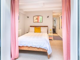 A bedroom with a bed and curtains at 14 Marine Parade in Lyme Regis