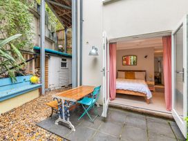 A bedroom with a bed and outdoor table at 14 Marine Parade, Lyme Regis