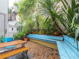 A garden with a table, chairs, and plants at 14 Marine Parade in Lyme Regis