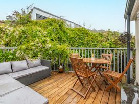 A balcony with a dining table and outdoor sofa at 14 Marine Parade Lyme Regis