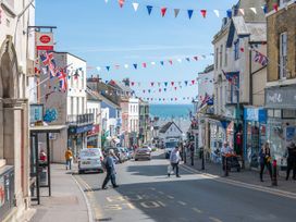 A street view with shops and ocean in the background at 14 Marine Parade in Lyme Regis