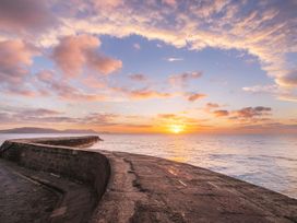 A sunset over the sea at 14 Marine Parade in Lyme Regis