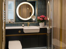 A bathroom with a sink and a mirror at Port House in Lyme Regis