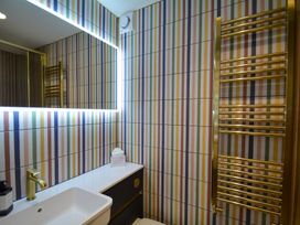 A bathroom with a sink and mirror at Port House in Lyme Regis