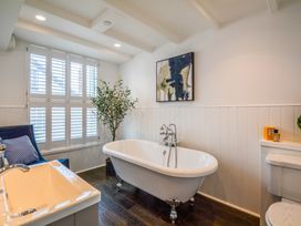 A bathroom with a free-standing bathtub and a toilet at Port House in Lyme Regis