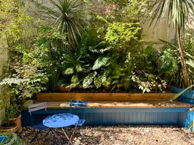 A garden with plants and seating area at Port House Lyme Regis