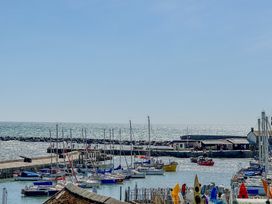 A harbor with numerous boats and yachts at Port House in Lyme Regis