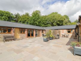 An outdoor area with seating and planters at Keepers Barn Bromyard