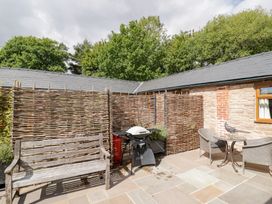 A garden area with patio furniture and a barbecue grill at Keepers Barn Bromyard