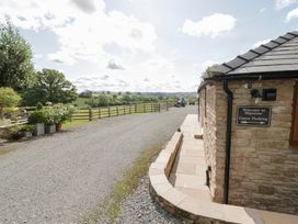 An outdoor parking area with a sign for guest parking at Keepers Barn Bromyard