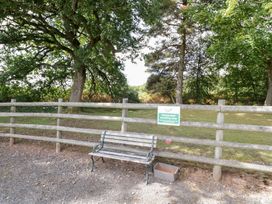 An outdoor area with a bench and a designated smoking area sign at Keepers Barn in Bromyard