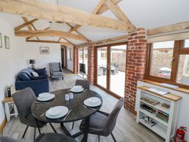 A living room with a dining table and chairs at The Cow Shed in Bromyard