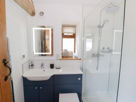 A bathroom with a shower and sink at The Cow Shed in Bromyard
