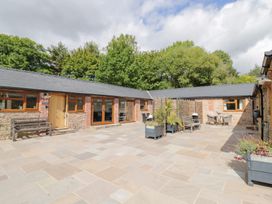 An outdoor area with seating and planters at The Cow Shed in Bromyard