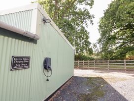 An electric vehicle charging point with a sign at The Cow Shed in Bromyard