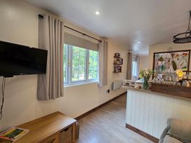 A living room with a television and window at Ty Barddu in Cwmorgan near Newcastle Emlyn
