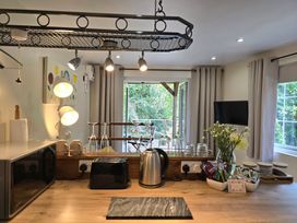 Kitchen with countertop appliances and a view of outdoor seating at Ty Barddu Cwmorgan near Newcastle Emlyn