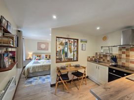 A studio apartment with a kitchen and sleeping area at Ty Barddu Cwmorgan near Newcastle Emlyn