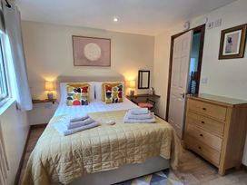 A bedroom with a bed and nightstand at Ty Barddu in Cwmorgan near Newcastle Emlyn