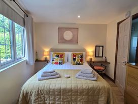 A bedroom with a double bed and side tables at Ty Barddu in Cwmorgan near Newcastle Emlyn