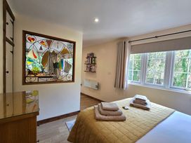 A bedroom with a bed and stained glass at Ty Barddu in Cwmorgan near Newcastle Emlyn