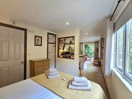 A bedroom with a bed and towels at Ty Barddu in Cwmorgan near Newcastle Emlyn