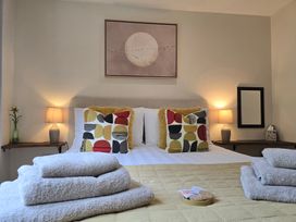 A bedroom with a bed and decorative pillows at Ty Barddu in Cwmorgan near Newcastle Emlyn